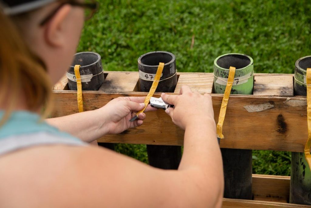 Jill Compogno uses a box cutter to set up a row of fireworks in Spokane’s Riverfront Park on Tuesday, July 3, 2018. Compogno has volunteered with Pyro Spectaculars, the company in charge of the fireworks show, for seven years. (Libby Kamrowski / The Spokesman-Review)