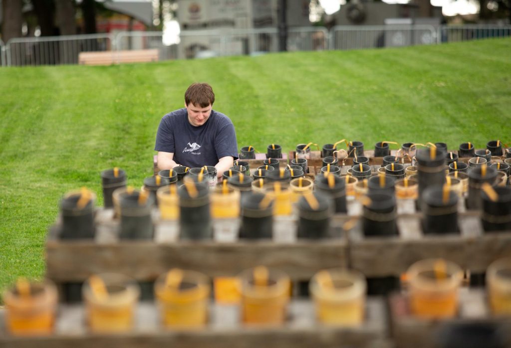 Bradley Blaylock, a first-year volunteer with Pyro Spectauclar, helps prepare fireworks at Riverfront Park's Havermale Point on Tuesday, July 3, 2018. Wednesday's show will feature about 280 cues to detonate, with two or more fireworks per cue that will go off. (Libby Kamrowski / The Spokesman-Review)