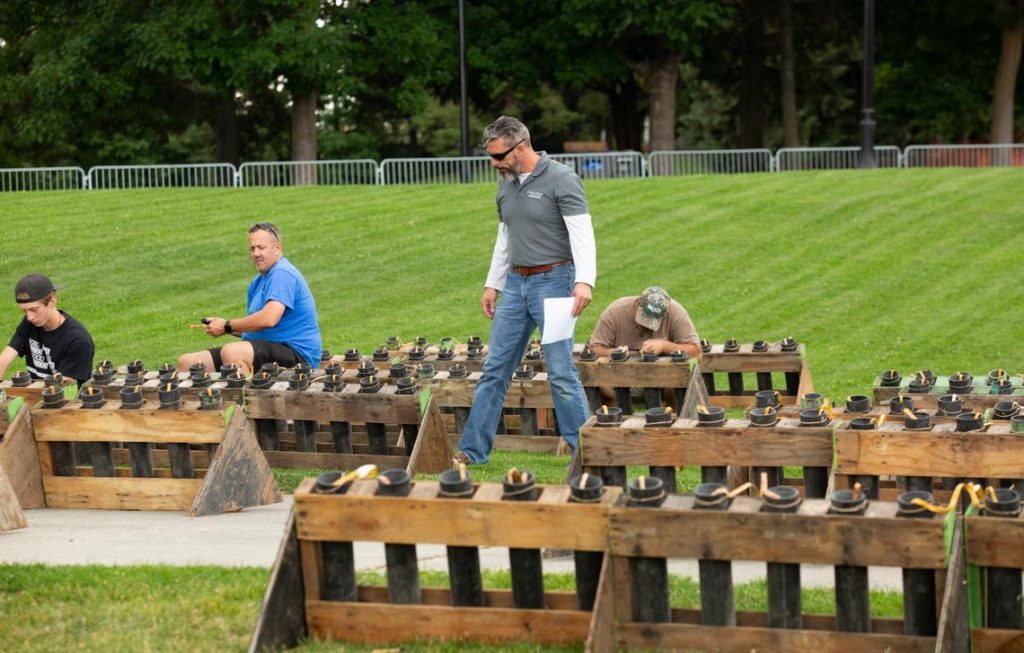 Matt King, Pyro Spectaculars’ supervisor for Spokane's annual Fourth of July fireworks show, inspects rows of fireworks on Tuesday, July 3, 2018, in Riverfront Park. The fireworks will detonate from Havermale Point. (Libby Kamrowski / The Spokesman-Review)