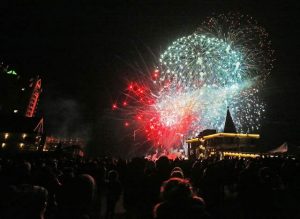 Spectators watch fireworks erupt in the sky above Lake Coeur d'Alene REsort Holiday light show fireworks display